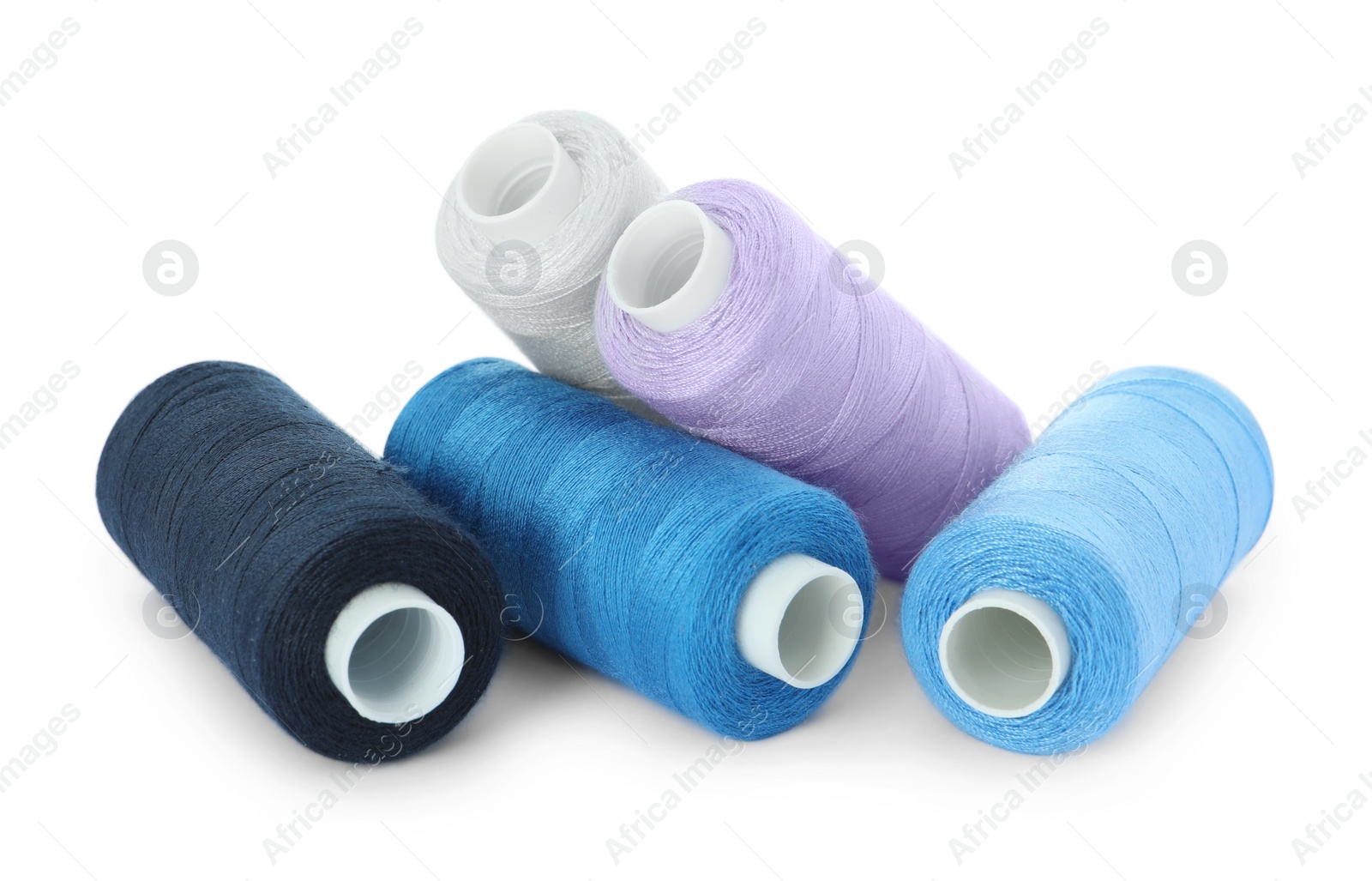 Photo of Many different colorful sewing threads on white background