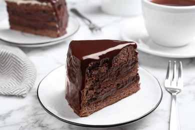 Photo of Delicious chocolate cake on white marble table, closeup