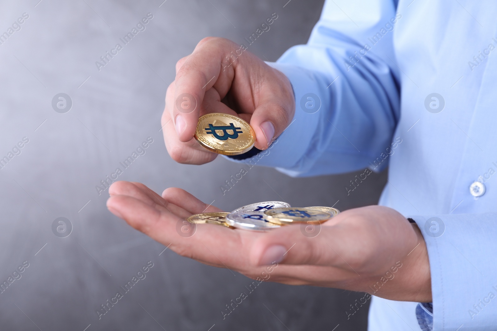 Photo of Man with bitcoins on color background, closeup. Space for text