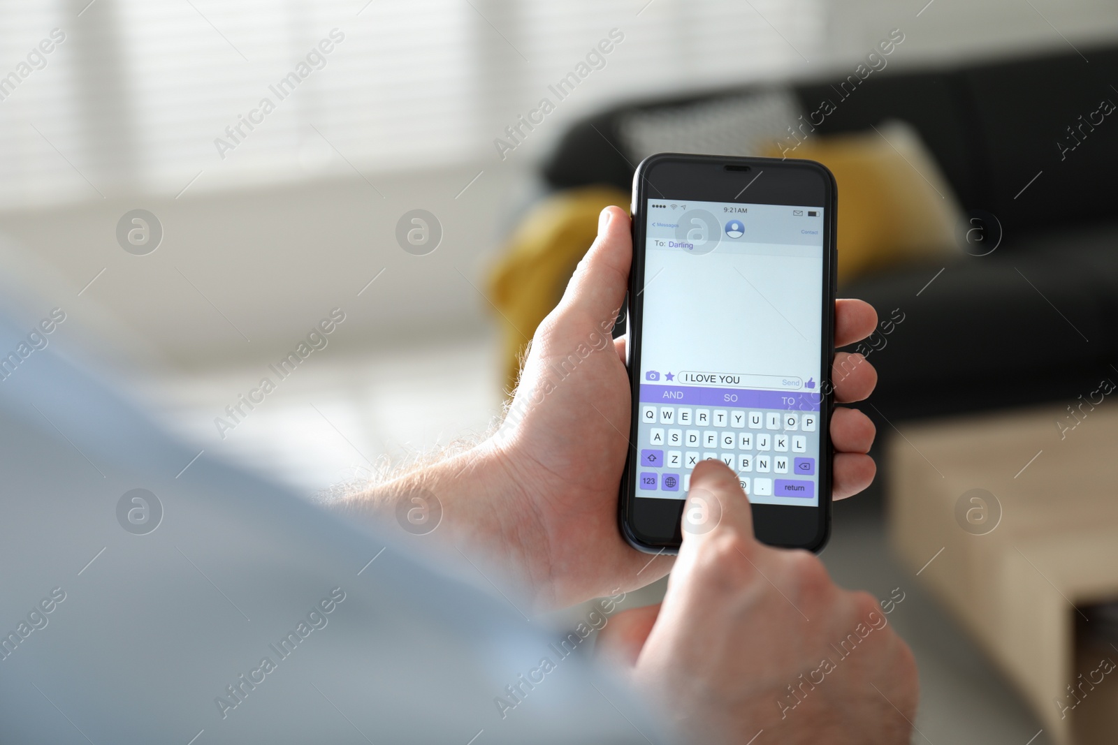 Photo of Man writing message with text I Love You on smartphone against blurred background, closeup