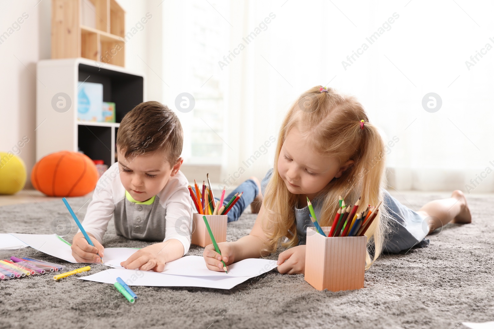 Photo of Little children drawing indoors. Learning and playing