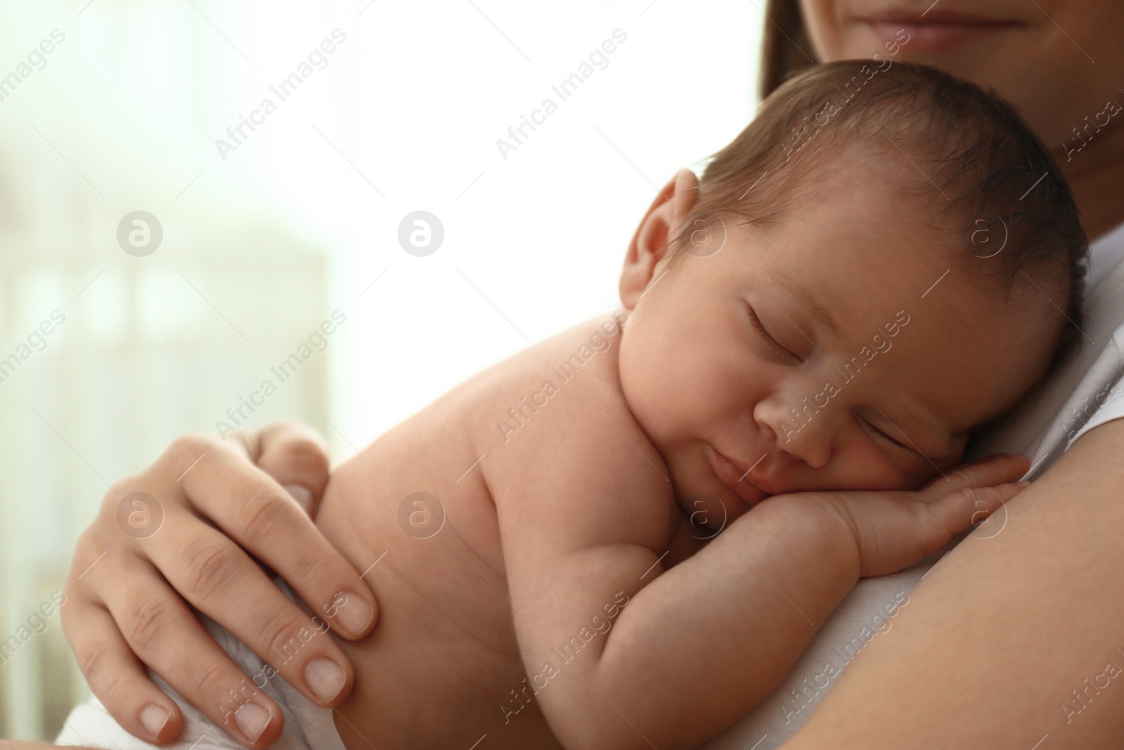 Photo of Young mother with her little baby at home