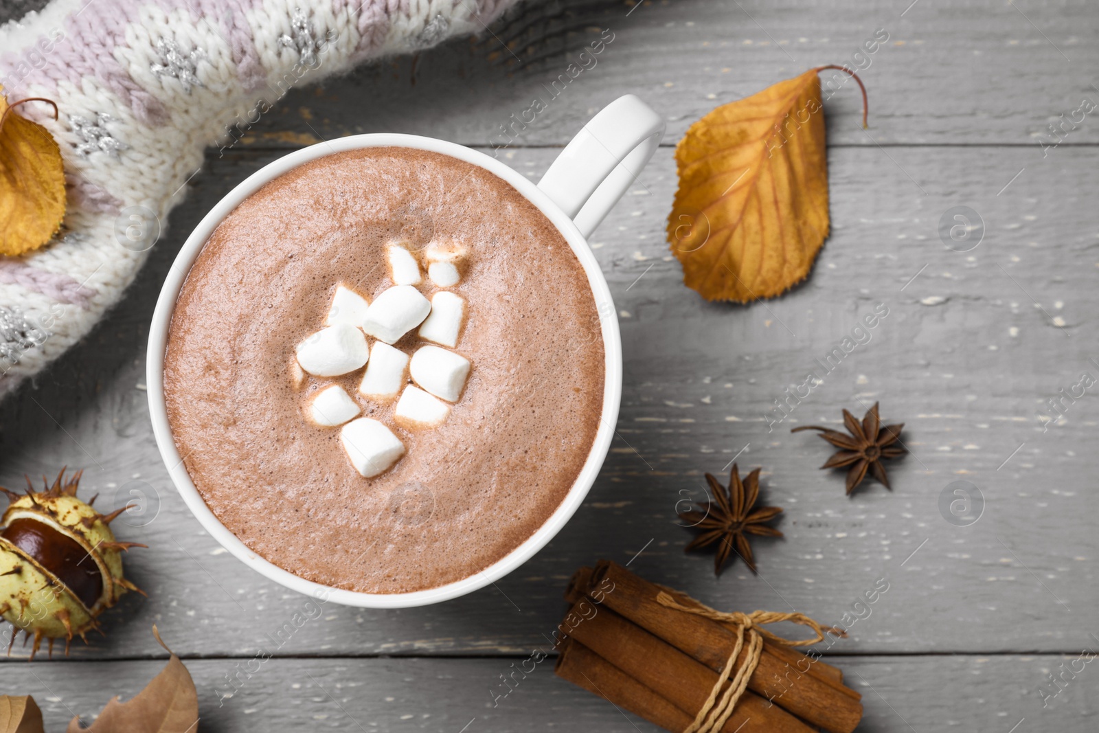 Photo of Flat lay composition with cup of hot drink on grey wooden table. Cozy autumn atmosphere