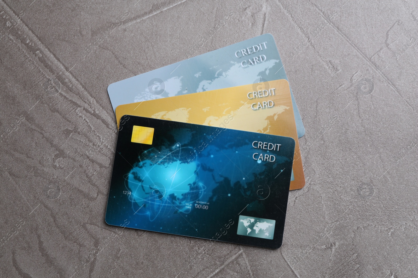 Photo of Credit cards on grey textured table, flat lay