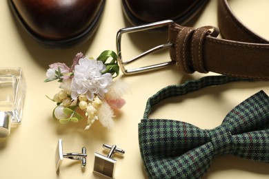 Wedding stuff. Composition with stylish boutonniere on yellow background, closeup