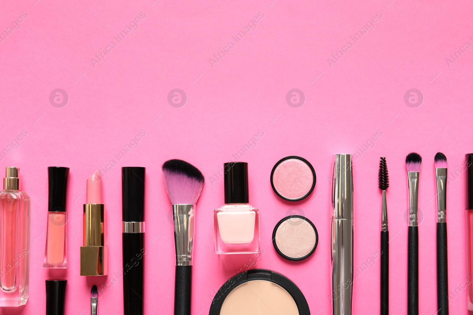 Photo of Flat lay composition with products for decorative makeup on pink background