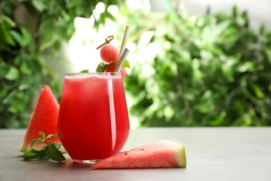 Delicious fresh watermelon drink on grey table. Space for text