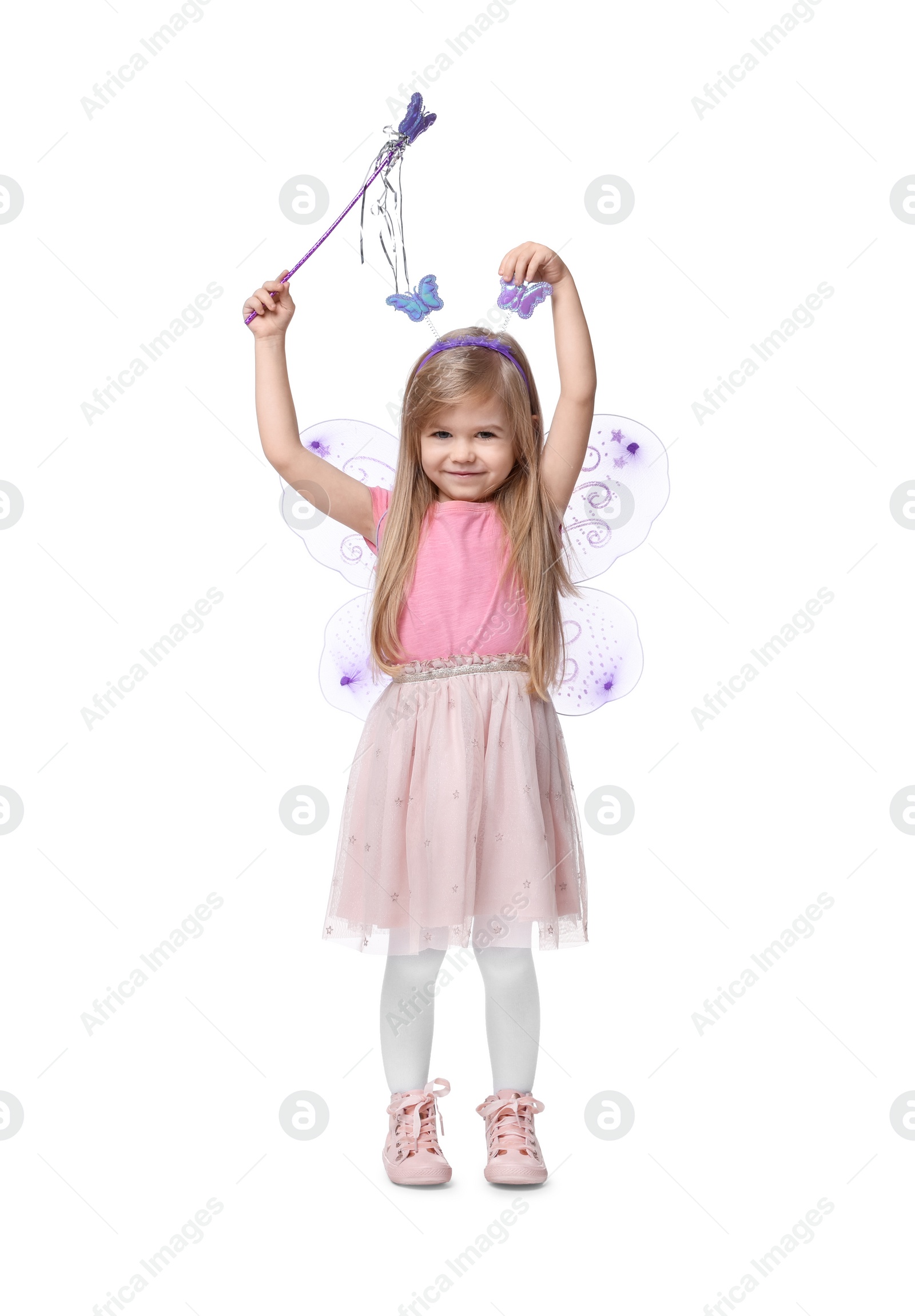 Photo of Cute little girl in fairy costume with violet wings and magic wand on white background