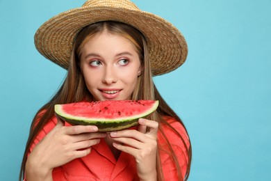 Beautiful girl with slice of watermelon on light blue background. Space for text
