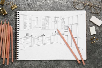 Image of Sketch of cityscape in notebook, glasses, pencils and other stationery on grey table, flat lay
