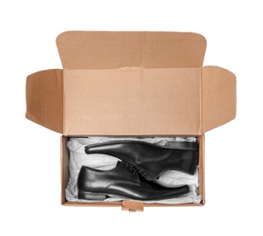 Box with elegant male shoes on white background