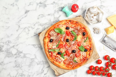 Photo of Flat lay composition with delicious pizza and ingredients on table