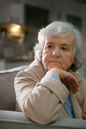 Photo of Portrait of elderly woman on sofa at home