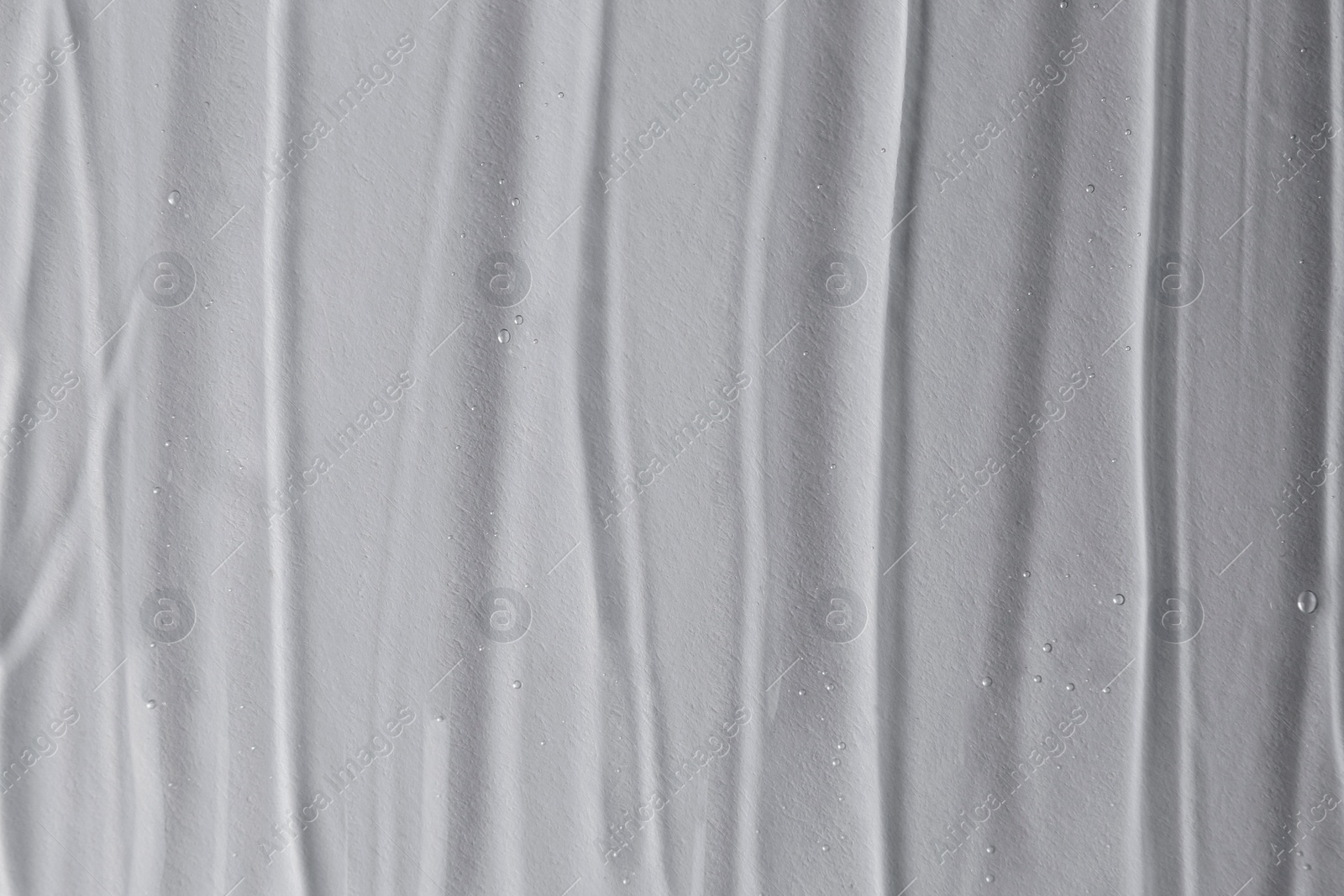 Photo of Texture of transparent shower gel on white background, closeup