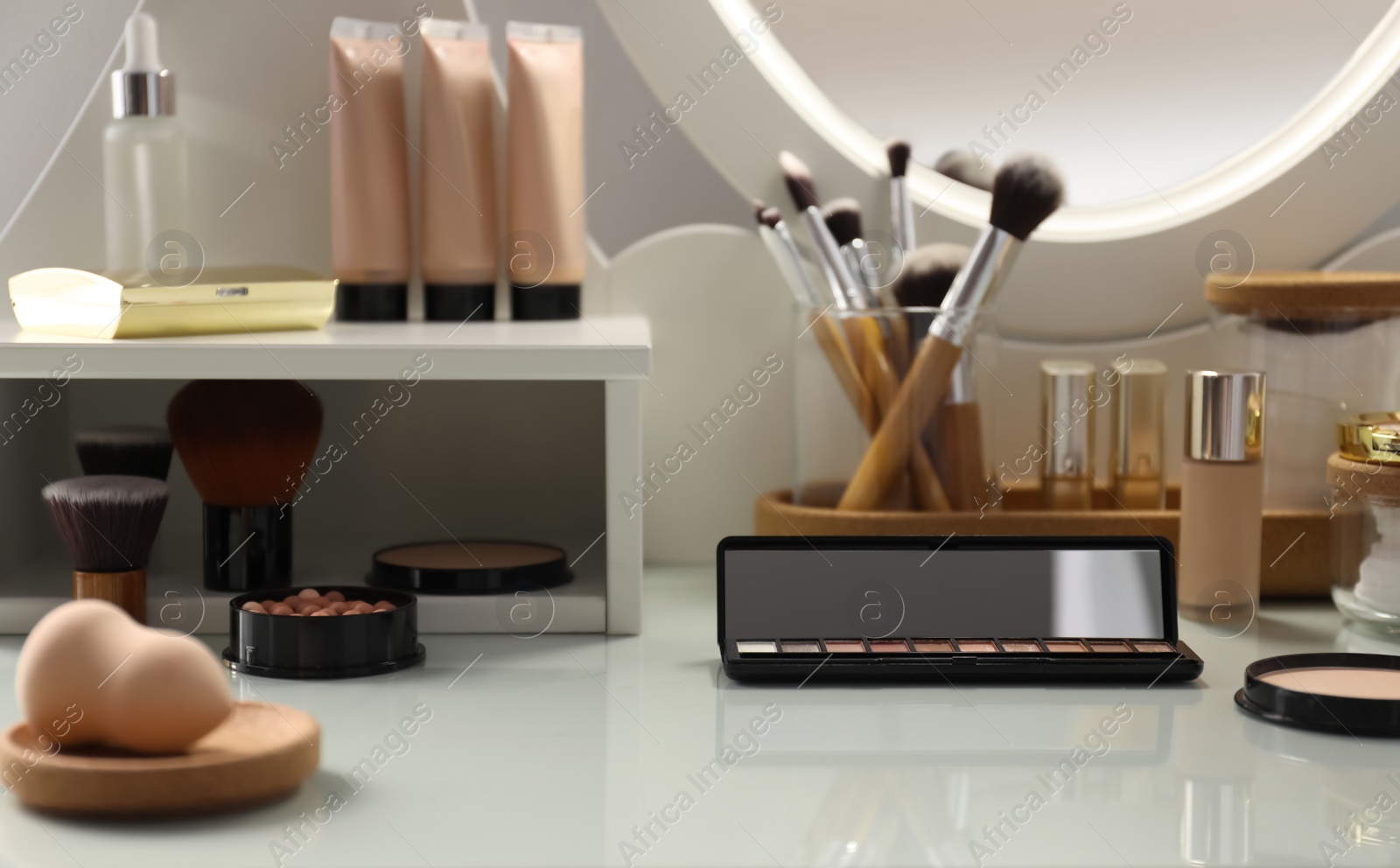 Photo of Many different cosmetic products on dressing table indoors