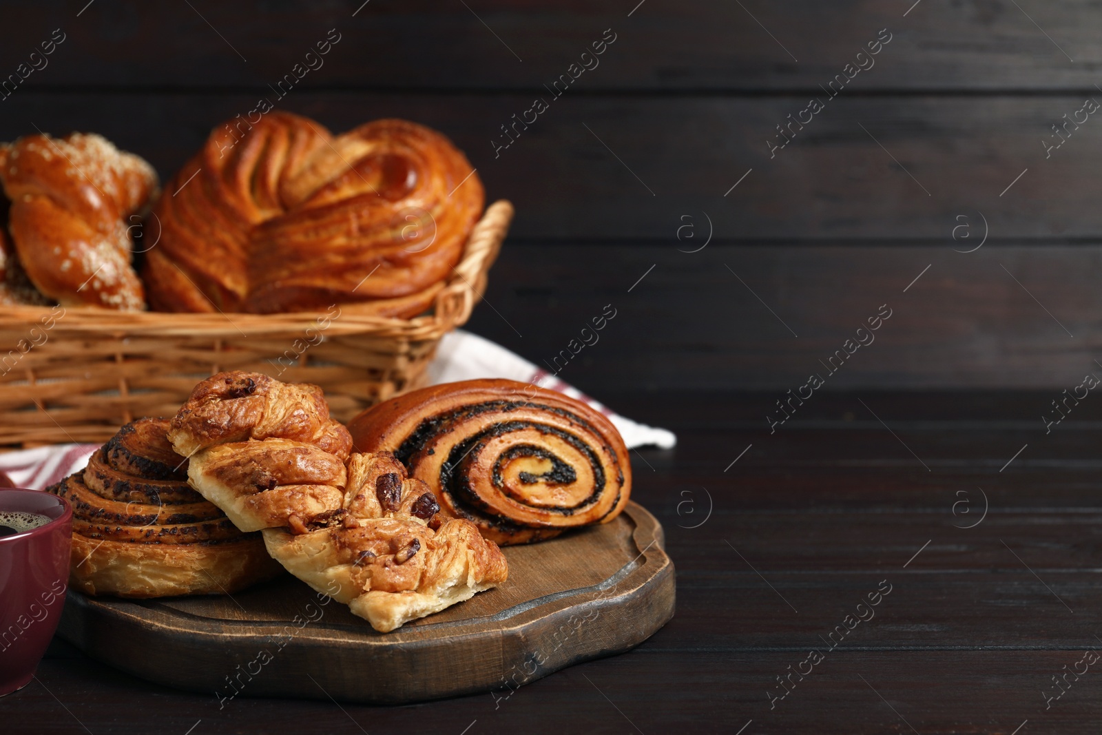 Photo of Different tasty freshly baked pastries on wooden table, space for text