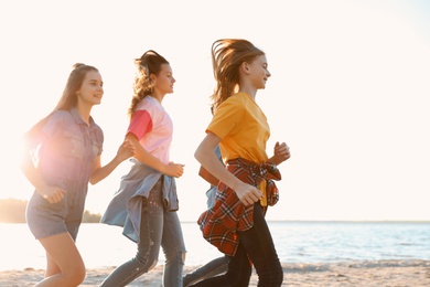 Group of children running on beach. Summer camp