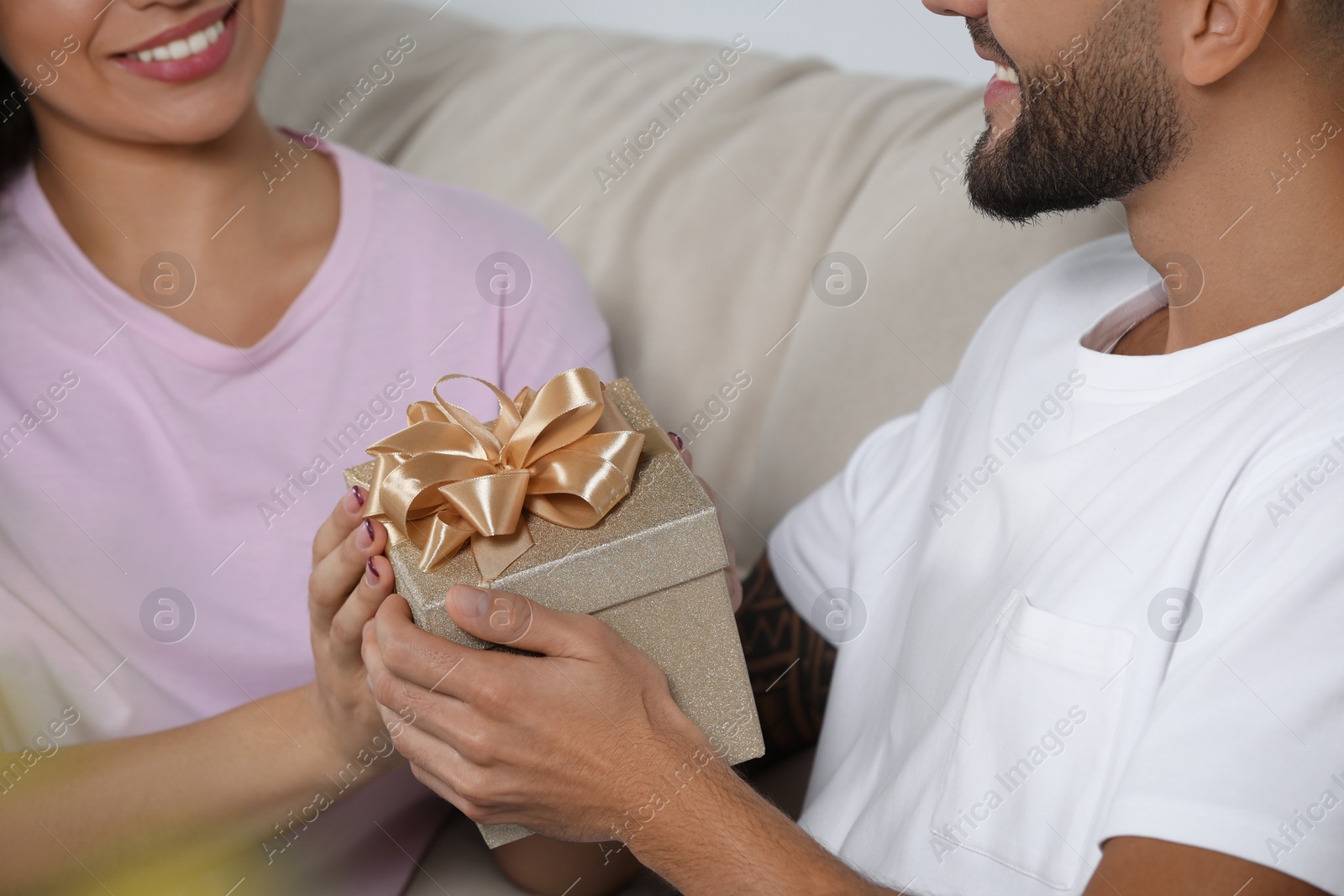 Photo of Lovely couple with beautiful gift, closeup view