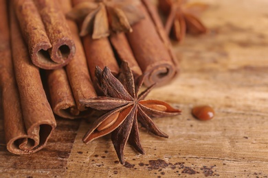 Cinnamon sticks with anise on wooden table