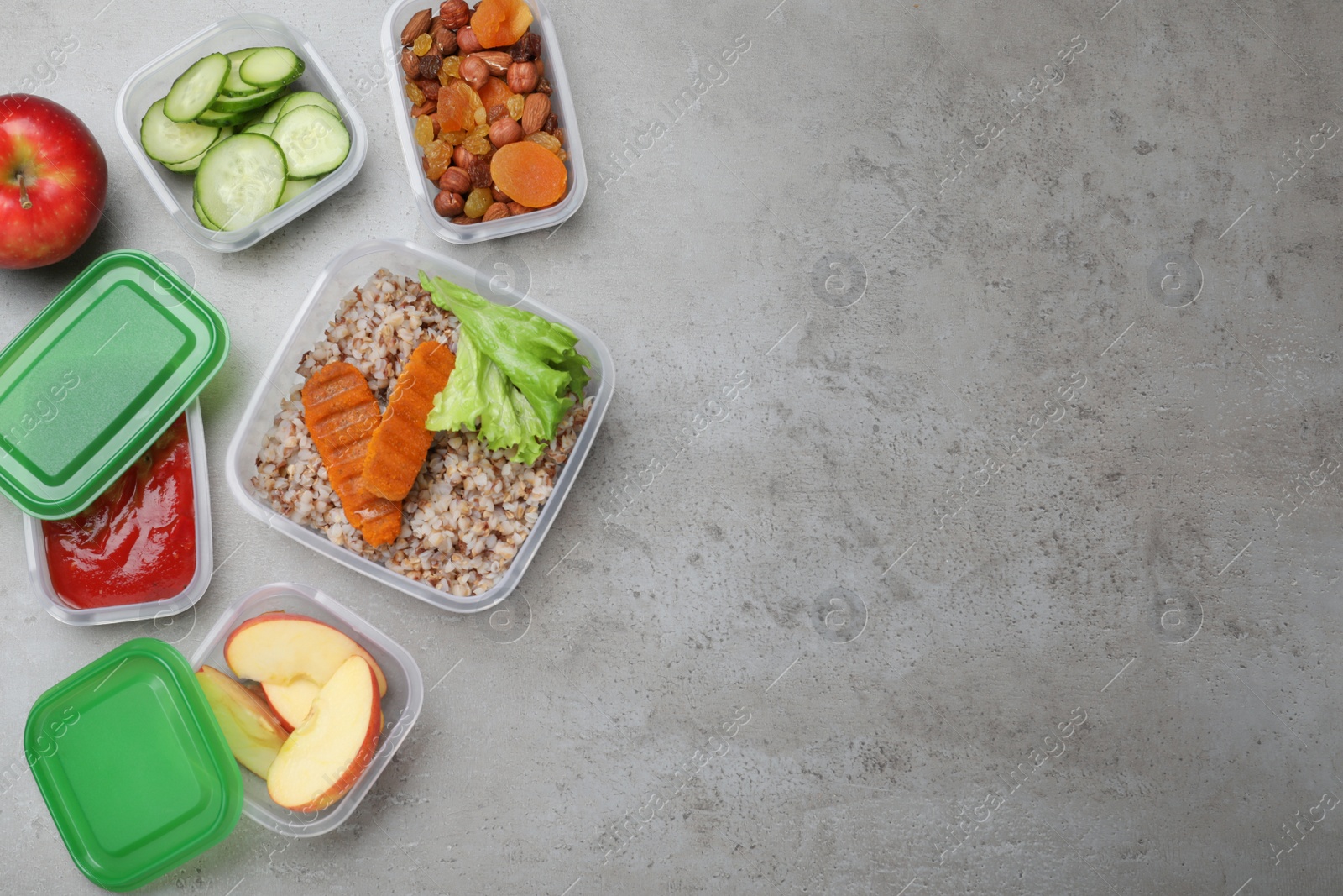 Photo of Set of plastic containers with fresh food on light grey table, flat lay. Space for text