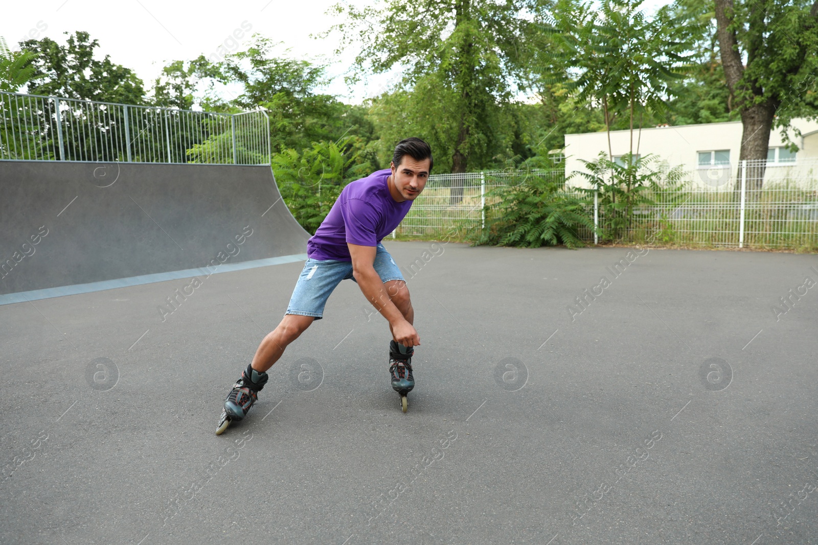 Photo of Handsome young man roller skating in park