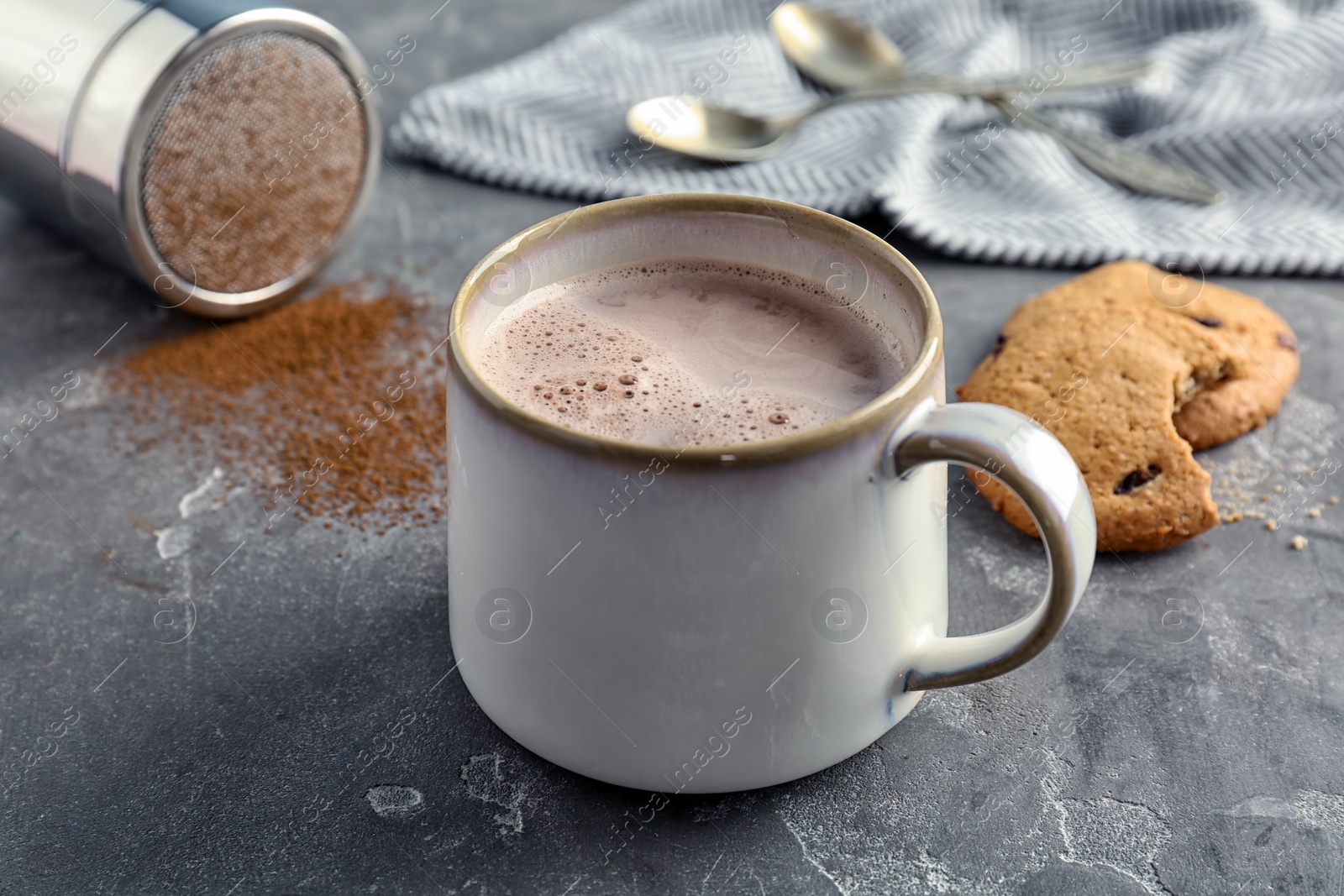 Photo of Mug with delicious hot cocoa drink on table