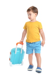 Cute little boy walking with blue suitcase on white background