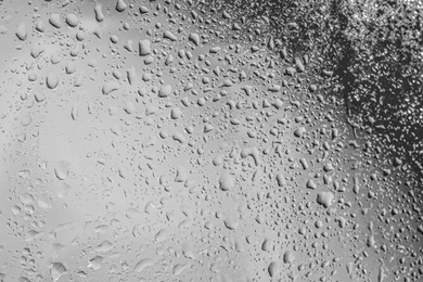 Photo of Rain drops on glass against grey background