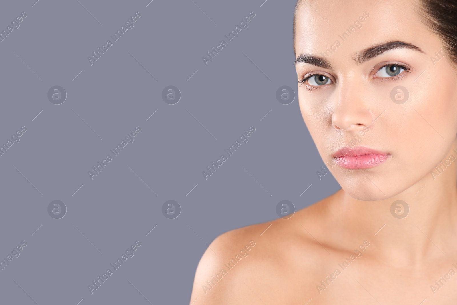 Photo of Portrait of beautiful young woman and space for text on grey background. Cosmetic surgery concept