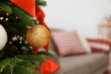 Photo of Christmas tree with decor on blurred background