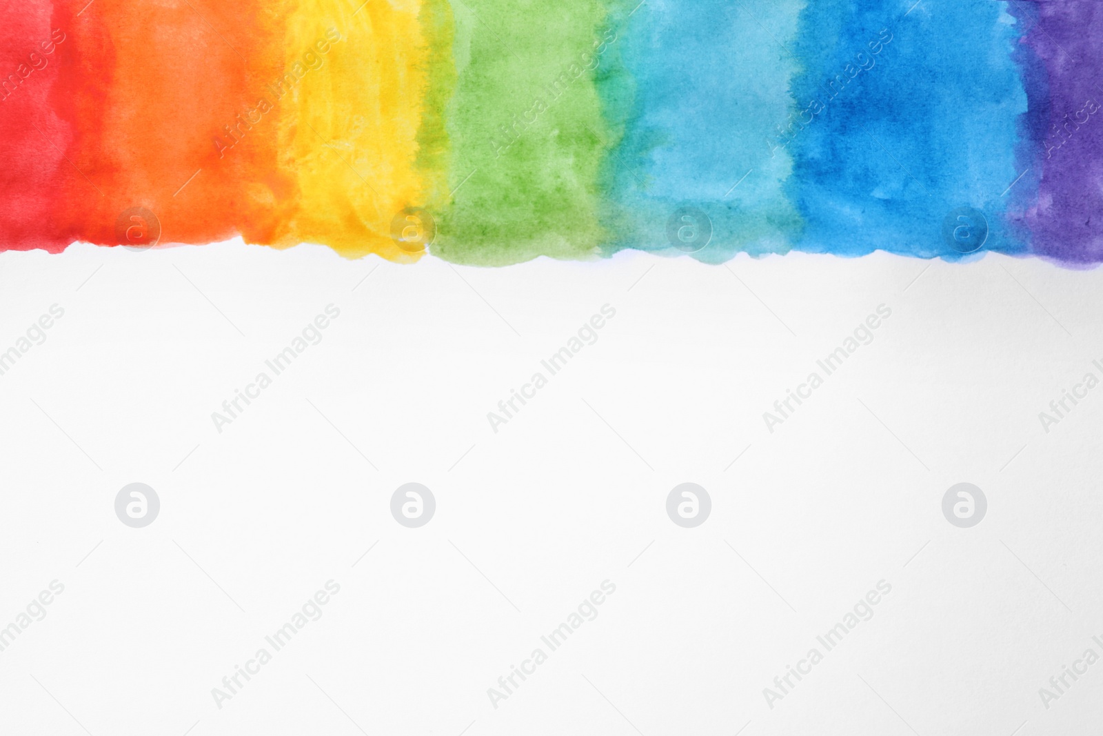 Photo of Rainbow drawing with watercolor paint on white paper, top view