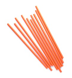 Photo of Orange paper cocktail straws on white background, top view