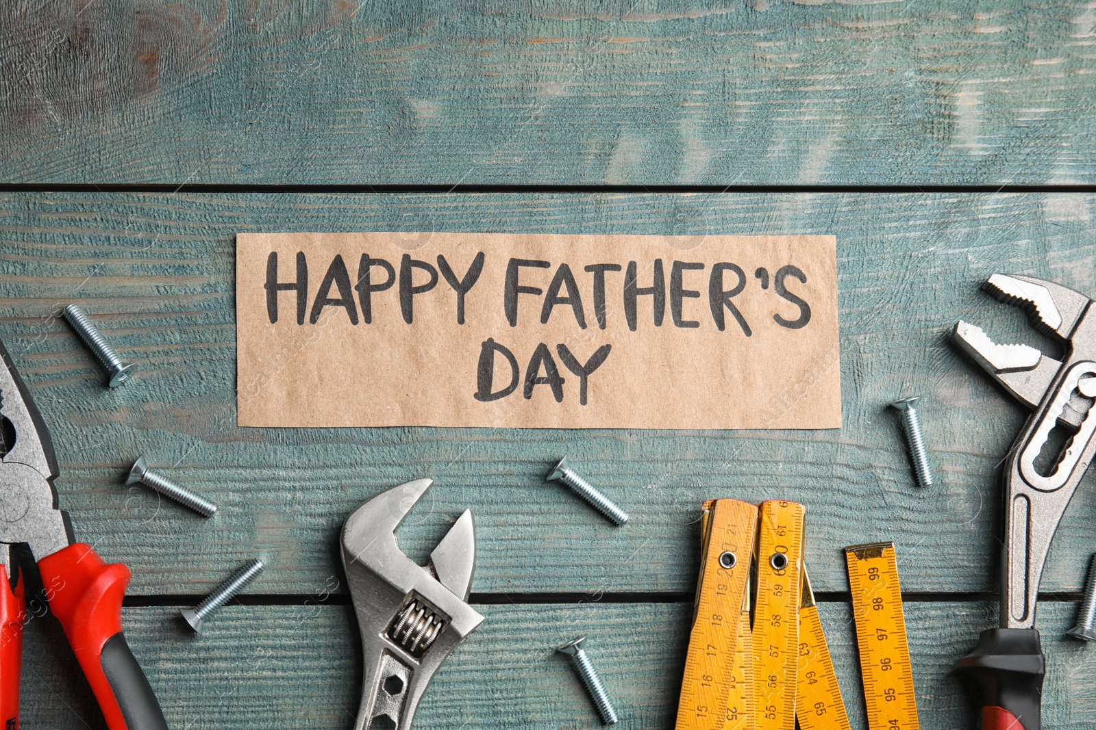 Photo of Flat lay composition with different tools on blue wooden background. Happy Father's Day