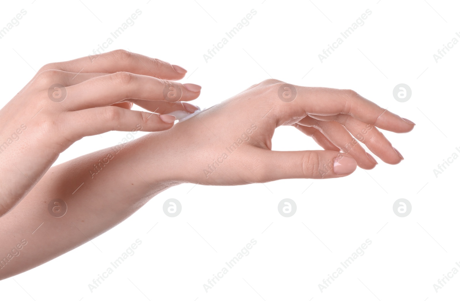 Photo of Woman applying cream on her hand against white background, closeup