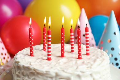 Photo of Delicious birthday cake with burning candles, closeup