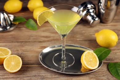 Photo of Lemon Martini cocktail and fresh fruits on wooden table