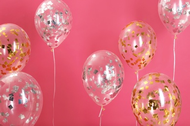 Photo of Bright balloons with sparkles on color background