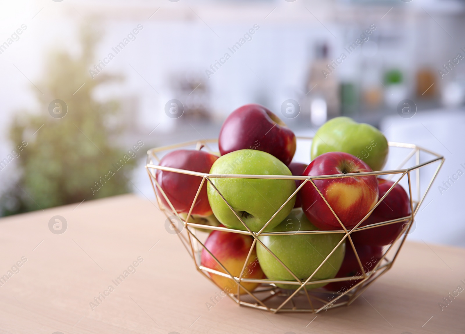 Photo of Ripe apples in decorative bowl on table