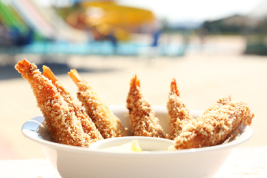 Delicious fried shrimps with sauce, closeup view