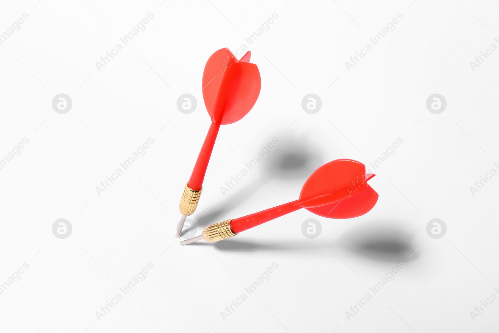 Photo of Red dart arrows for game on white background