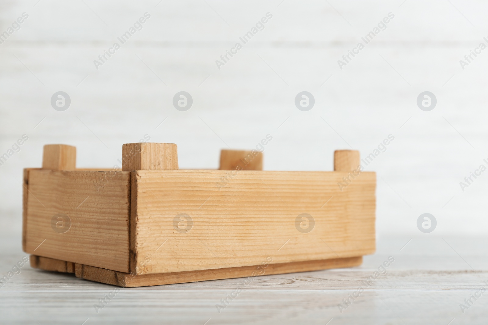 Photo of Wooden crate on table against light background. Space for text