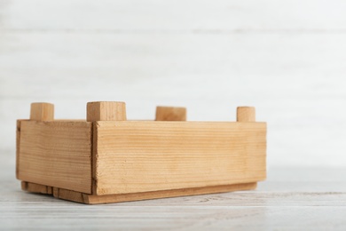 Photo of Wooden crate on table against light background. Space for text