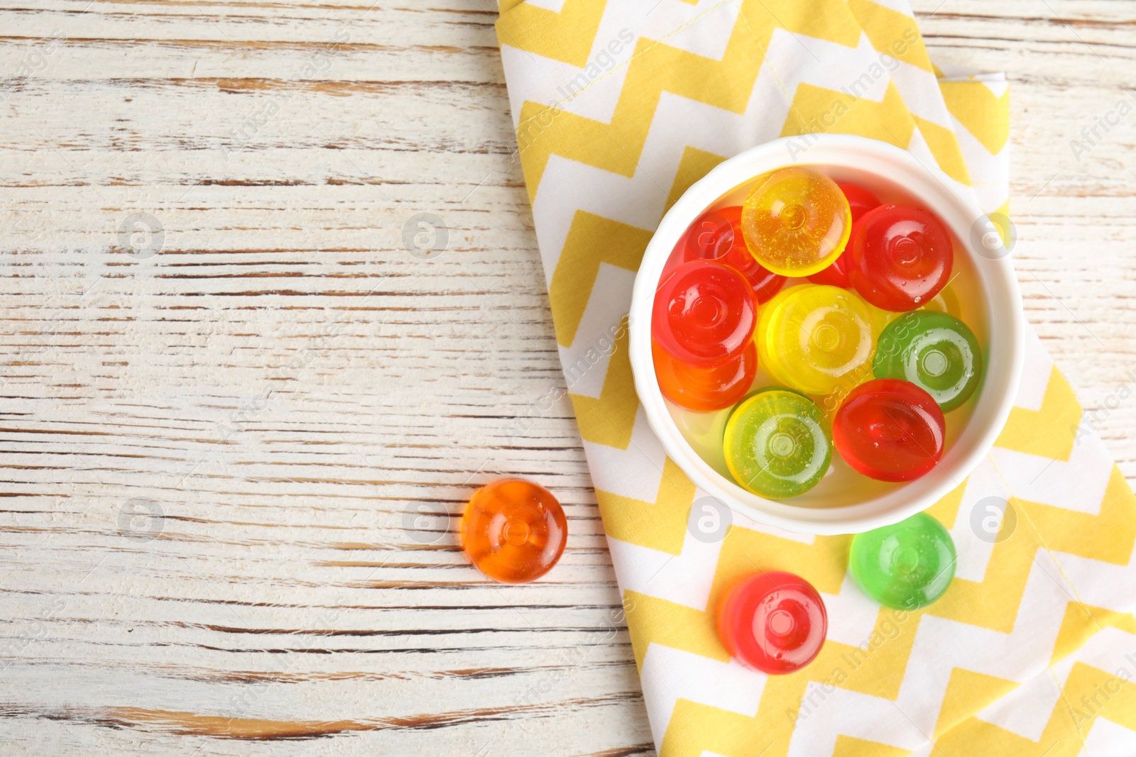 Photo of Flat lay composition with delicious colorful candies and space for text on wooden background