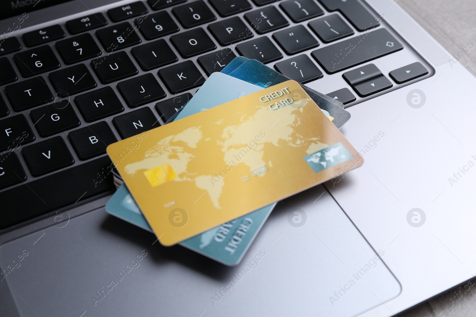 Photo of Laptop with credit cards on grey table