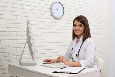 Photo of Portrait of pediatrician at table in clinic