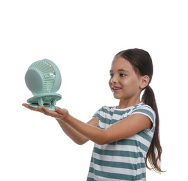 Photo of Little girl enjoying air flow from portable fan on white background. Summer heat