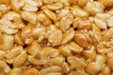 Photo of Delicious peanut bar (kozinaki) as background, top view