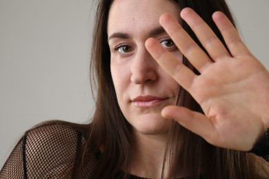 Photo of Beautiful young woman on light grey background, closeup