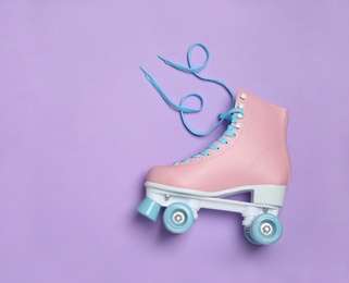 Stylish quad roller skate on color background, top view with space for text