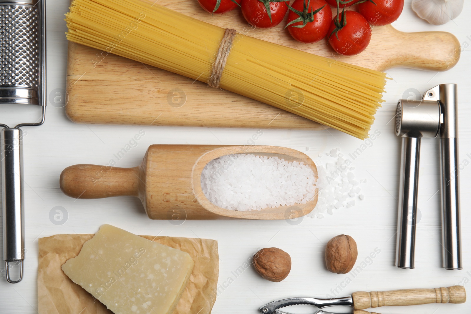 Photo of Cooking utensils and ingredients on white wooden table, flat lay